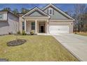 Inviting home with a well-kept lawn, complemented by a two-car garage and a quaint front porch at 221 Caledonia Ct, Peachtree City, GA 30269