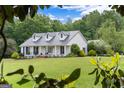 Beautiful home with a metal roof, and well-manicured lawn and landscaping at 333 Old Carrollton Rd, Roopville, GA 30170