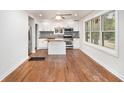 Open kitchen featuring white cabinets, an island, butcher block countertops, and stainless steel appliances at 2952 Diana Sw Dr, Atlanta, GA 30315