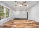 Bright living room featuring a modern ceiling fan, natural light, and sleek, wood-look floors at 2952 Diana Sw Dr, Atlanta, GA 30315