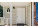 Inviting front porch with a unique window detail and classic lantern fixture enhances curb appeal at 1360 Maple Valley Ct, Union City, GA 30291