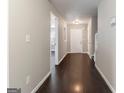 Long hallway featuring hardwood floors, neutral paint, and access to multiple rooms of the house at 1360 Maple Valley Ct, Union City, GA 30291