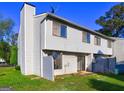 Back of townhome with small fenced patio area and vinyl siding at 288 Country Club Dr, Jonesboro, GA 30238