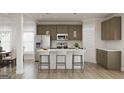 Stylish kitchen with stainless steel appliances, white countertops, and island with bar seating at 1205 Trombone Way # 3, Mcdonough, GA 30252