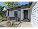 Inviting front entrance featuring a covered porch and modern design at 3336 Country Creek Nw Dr, Kennesaw, GA 30152