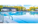View of the community pool featuring a 5 FT diving sign and various umbrellas at 100 Silver Moon Dr, Loganville, GA 30052