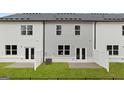 A newly constructed home with a spacious backyard, concrete patio, and privacy fencing at 322 Sound Cir # 118, Stockbridge, GA 30281