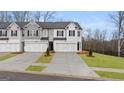 Modern townhomes featuring two-car garages, well-manicured lawns, and neutral color schemes at 326 Sound Cir # 119, Stockbridge, GA 30281