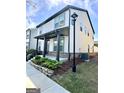 Charming two-story home featuring a covered porch and a well-maintained, landscaped front yard at 4438 Encore Park Xing, Duluth, GA 30097