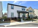Charming two-story home featuring a covered porch and a well-maintained, landscaped front yard at 4438 Encore Park Xing, Duluth, GA 30097