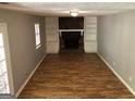 Inviting living room with wood floors, cozy fireplace, and built-in shelving at 275 Summertown Dr, Stockbridge, GA 30281