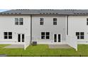 Townhome backyards with patios, privacy fences, and green grass create a cozy outdoor living space at 334 Sound Cir # 120, Stockbridge, GA 30281