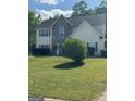 Charming two-story home with stone accents, blue shutters and a landscaped yard at 117 Rendition Dr, Mcdonough, GA 30253