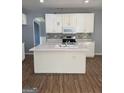 Kitchen with white cabinets, central island, and modern appliances at 117 Rendition Dr, Mcdonough, GA 30253