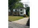 Two-story home with a cozy front porch, manicured lawn, and convenient driveway at 1962 Compton Dr, Atlanta, GA 30315