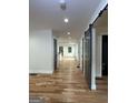 Bright hallway with hardwood floors and modern barn doors, leading to open rooms at 1962 Compton Dr, Atlanta, GA 30315