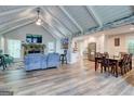 Spacious living room and dining room area featuring vaulted ceilings, fireplace and wood floors at 3861 Hanover Ct, Marietta, GA 30062