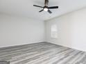 Minimalist bedroom design, showcasing modern vinyl flooring, neutral walls, bright natural light, and a ceiling fan at 3353 Arabian Farm Ln, Dacula, GA 30019