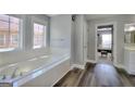 Bright bathroom with dual windows over a soaking tub and dark hardwood floors at 5845 Princeton Run Trl, Tucker, GA 30084