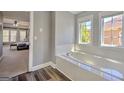 Bright bathroom with dual windows over a soaking tub and dark hardwood floors at 5845 Princeton Run Trl, Tucker, GA 30084