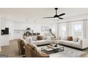 Bright and open-concept living room featuring contemporary decor and seamless flow to the kitchen and dining area at 782 Grande Bishop Dr, Fairburn, GA 30213