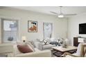 Bright living room featuring neutral-toned furniture, large windows, and contemporary decor at 787 Grande Bishop Dr, Fairburn, GA 30213