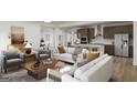 Open-concept living room featuring modern decor, hardwood floors, and natural light at 791 Grande Bishop Dr, Fairburn, GA 30213