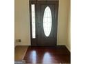 Elegant front door with decorative glass insert and gleaming hardwood floors at 128 Kelleytown Woods Dr, Mcdonough, GA 30252