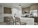 Modern kitchen with stainless steel appliances, a large island, and stylish bar stools at 2278 Santa Fe St, Morrow, GA 30260