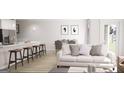 Bright open-concept living space with barstool seating and modern decor at 2280 Santa Fe St, Morrow, GA 30260