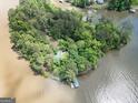 Expansive aerial view of a charming home nestled among lush green trees and waterfront at 2000 Campbell Rd, Covington, GA 30014