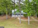 Beautiful two-story home with a lush green lawn surrounded by mature trees at 2000 Campbell Rd, Covington, GA 30014