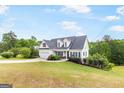 Inviting home with a well-maintained lawn, landscaping, and an attached two-car garage at 447 W Wind Dr, Villa Rica, GA 30180