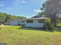 This home features dark shutters and a large yard, perfect for relaxing or playing outside at 140 Whitehead Sw Rd, Oxford, GA 30054