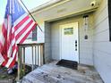 Inviting entrance with a classic white door, an American flag, and a security camera at 140 Whitehead Sw Rd, Oxford, GA 30054