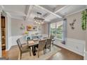 Elegant dining room featuring coffered ceilings, stylish lighting, and views to the front yard at 228 Madison Grace Ave, Mcdonough, GA 30252