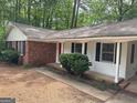 Single-story home featuring brick accents, a covered entryway and lush landscaping at 260 Pinehurst Dr, Stockbridge, GA 30281