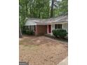 Charming single-story home featuring brick accents, a covered entryway, and mature landscaping at 260 Pinehurst Dr, Stockbridge, GA 30281