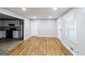 Open-concept living area with refinished hardwood floors connecting to the kitchen at 3903 Rex Rd, Rex, GA 30273