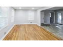 Bright living room featuring newly refinished hardwood floors and modern neutral paint at 3903 Rex Rd, Rex, GA 30273
