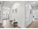 Inviting entryway with shiplap walls, a bench, and views into the bedroom and front door at 61 Main St, Moreland, GA 30259