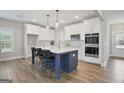 Modern kitchen features a large island, stainless steel appliances, and sleek white cabinetry at 61 Main St, Moreland, GA 30259