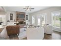 Cozy living room featuring a brick fireplace, stylish furniture, and ample natural light at 61 Main St, Moreland, GA 30259