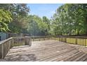 Expansive wooden deck, perfect for entertaining or enjoying the serene backyard views with ample space at 3580 Dorris Cir, Douglasville, GA 30135