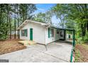 Charming single-story home with a covered carport and a well-maintained front lawn at 3118 Rockbridge Rd, Avondale Estates, GA 30002