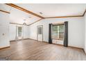 Spacious living room with new floors, ample natural light, and vaulted ceilings with exposed beams at 3118 Rockbridge Rd, Avondale Estates, GA 30002