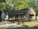Attractive brick and siding home with covered front porch and newly poured driveway at 135 Church St, Palmetto, GA 30268