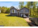 Two-story home with an attached garage, neutral exterior, a well-manicured lawn, and a driveway at 231 Breckenridge Ln, Powder Springs, GA 30127