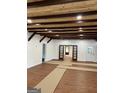 Spacious room with wood-look floors, wood beam ceilings, recessed lights and neutral walls at 854 Clearwater Rd, Sharpsburg, GA 30277