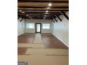 Bright and airy living room with wood-look floors, neutral walls, and wood beam ceilings at 854 Clearwater Rd, Sharpsburg, GA 30277